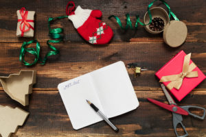 Christmas letter writing on paper on wooden background with decorations